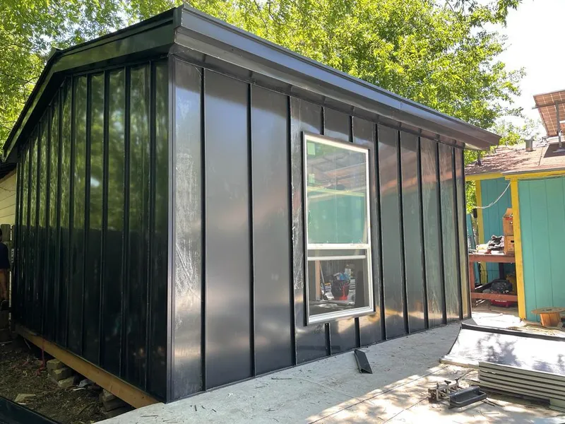 Black standing seam metal wall panels for Roof Inspection in Home Gardens