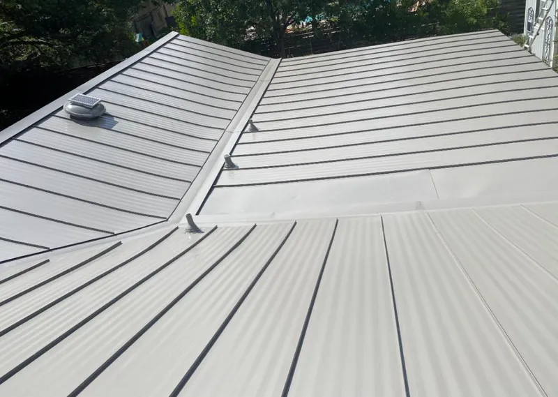 Solar attic fan installed on a metal roof for Roof Ventilation in Home Gardens